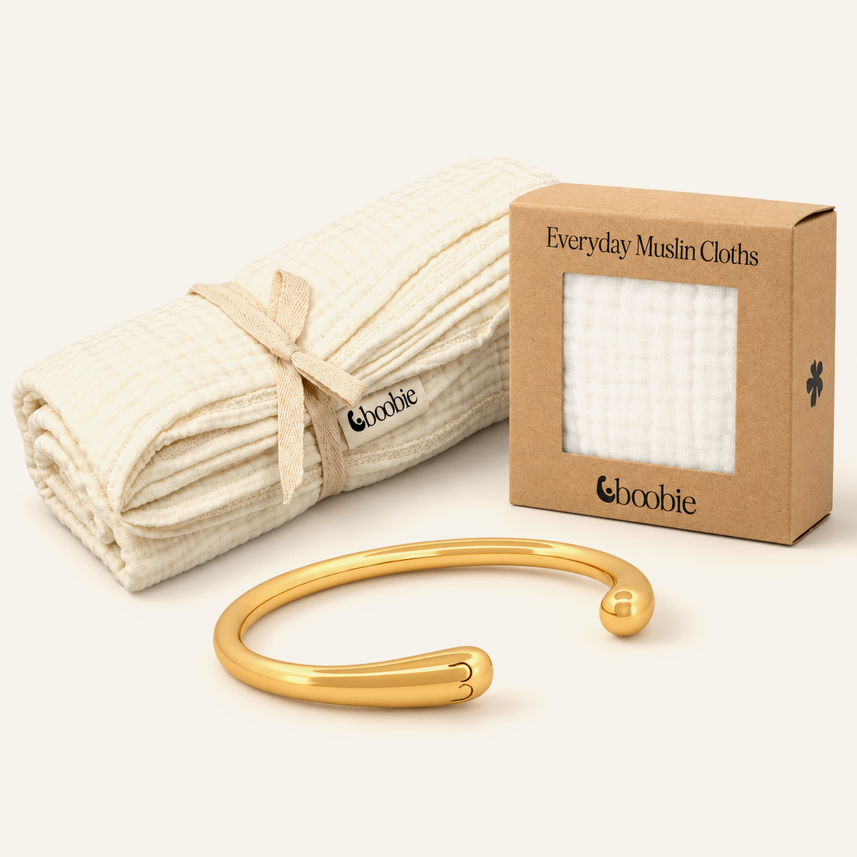 New Mum Gift Set with one gold Signature Boobie Bracelet, one Cloud Muslin Blanket and one five-pack of reusable muslin baby wipes.