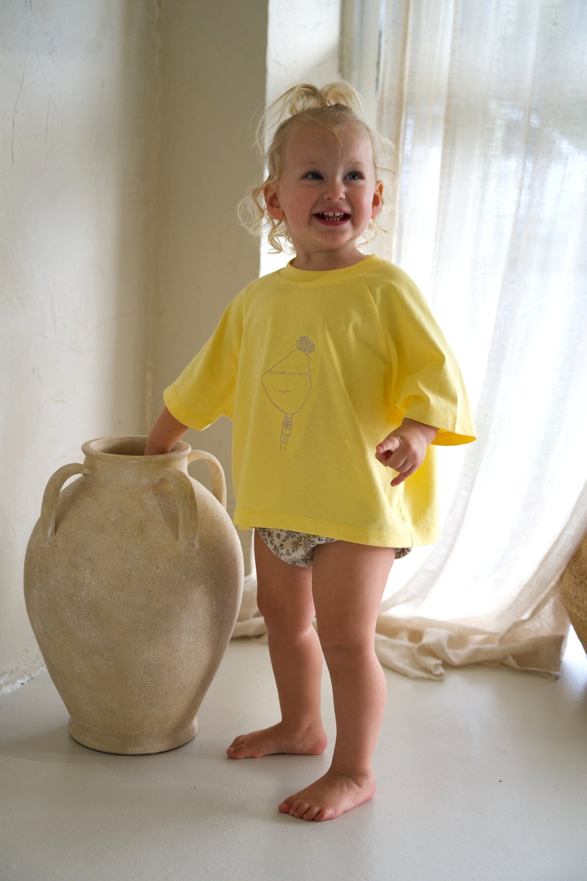 Child wearing the Dandelion Momenta kids tee at the Blanc Space studio shoot.