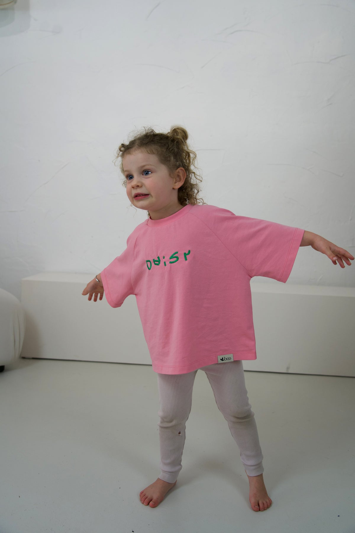 Child wearing the Fairy Floss Momenta kids tee with their embroidered lettering.