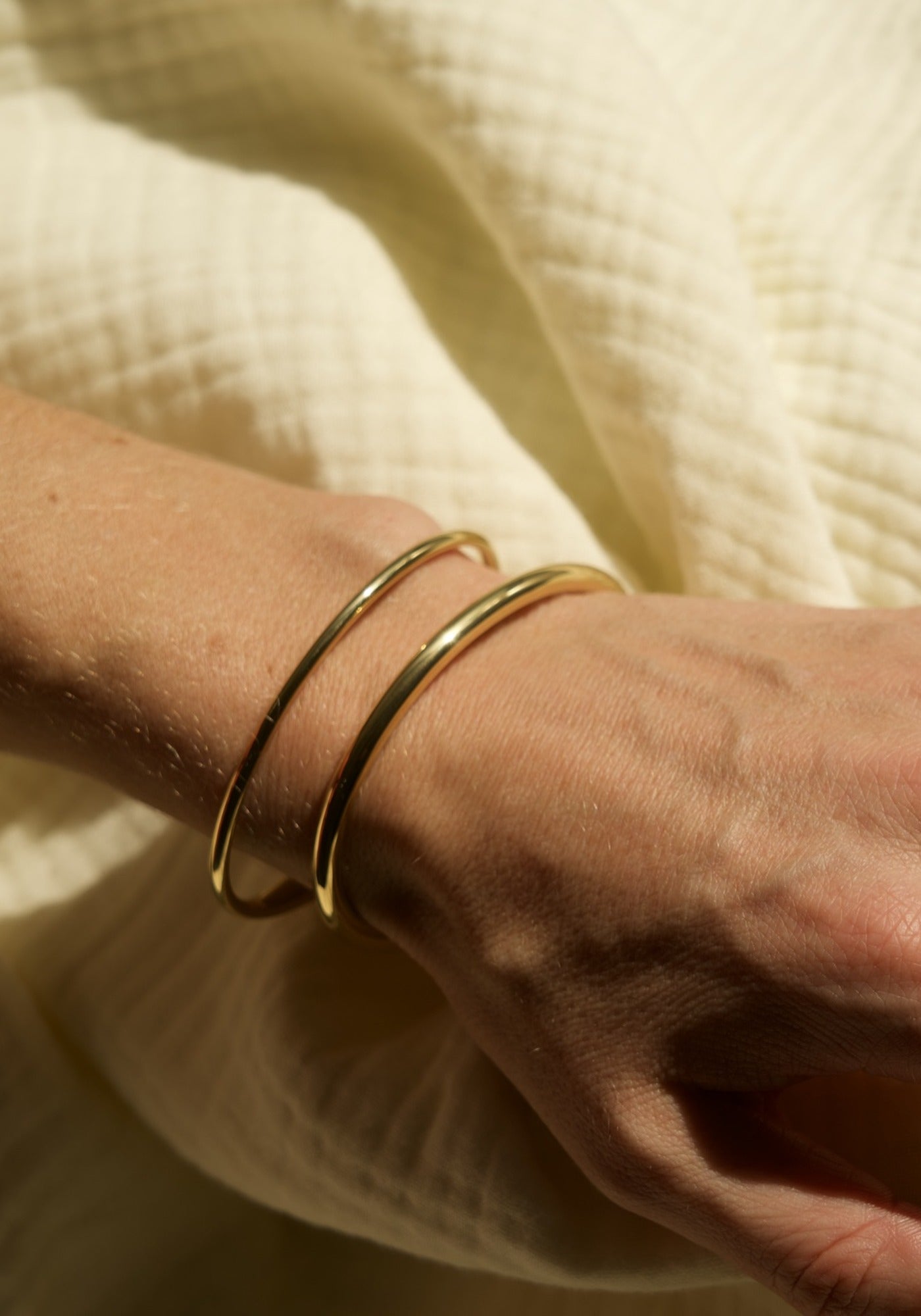 Minimal Bracelet in gold worn on the wrist