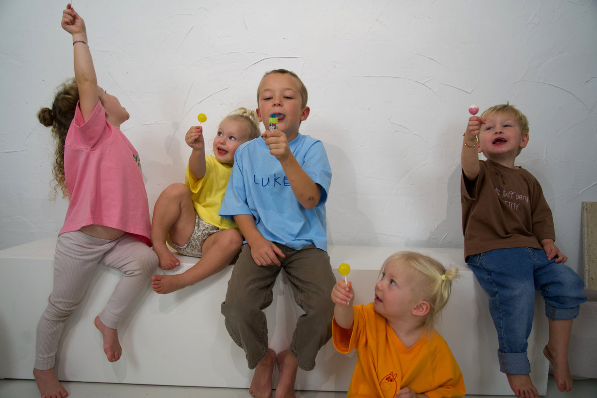 Children wearing Momenta tees in Fairy Floss, Blueberry, Dandelion, Mandarin and Mud at the studio shoot.