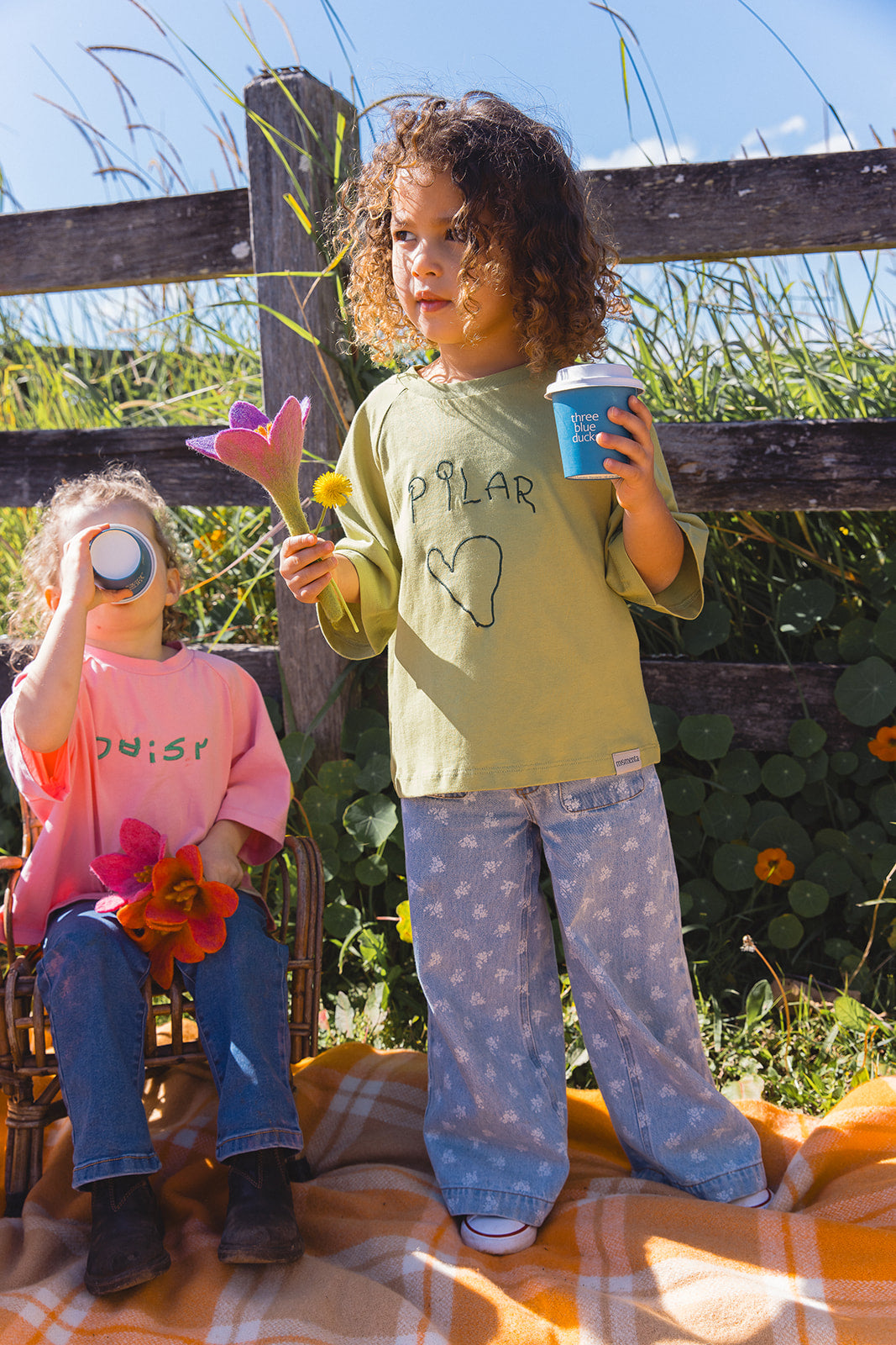 Momenta farm shoot: a child in a green tee with an embroidered handwritten name and heart, beside a child in a pink tee.